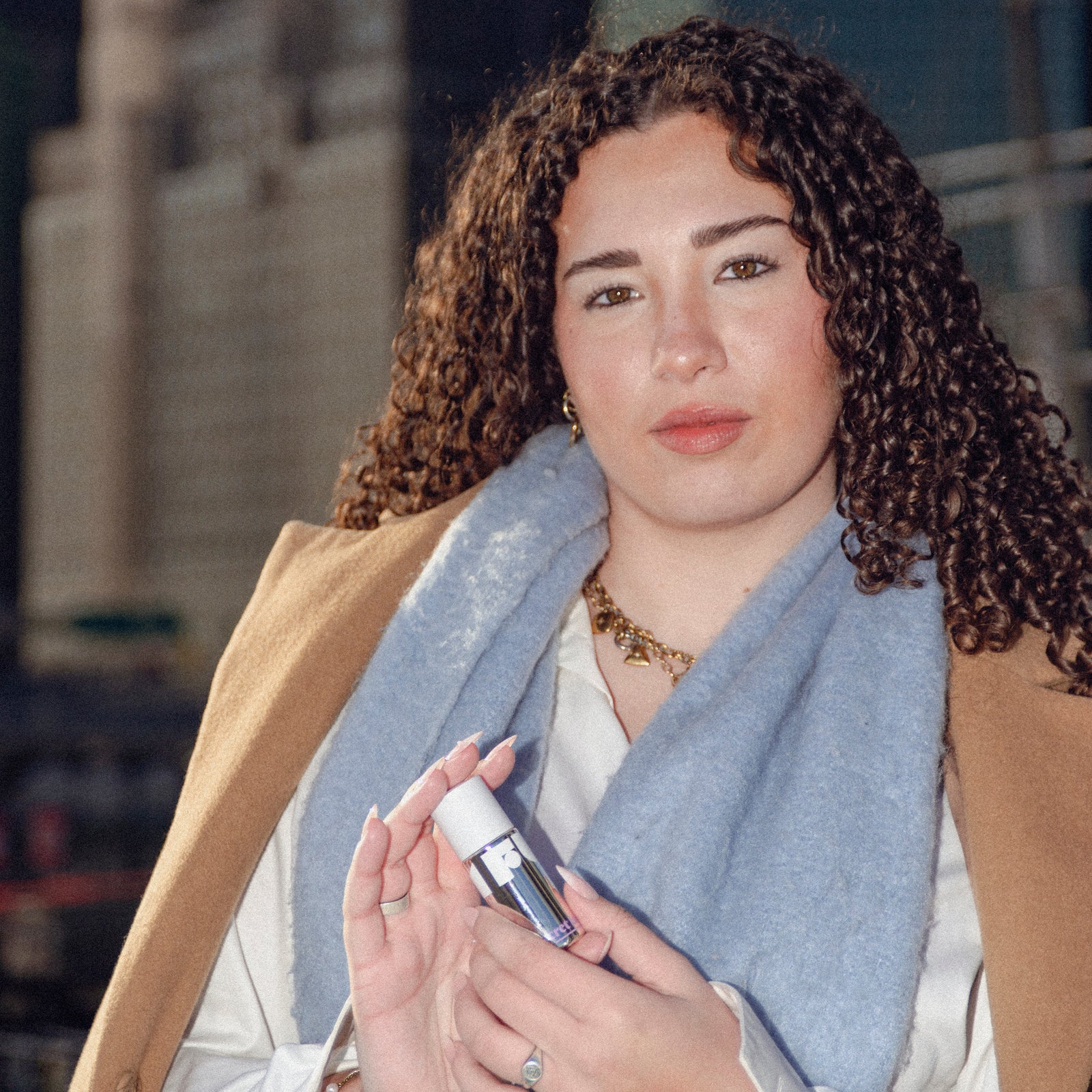 Woman holding a bottle with a blurred background