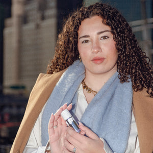Woman holding a bottle with a blurred background
